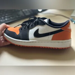 Nike orange and black golf shoes